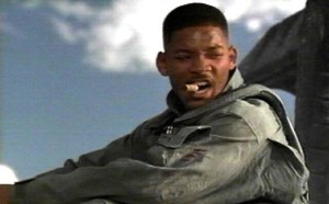 Will Smith welcoming an alien to earth by smoking a big fat cigar over its unconscious body.